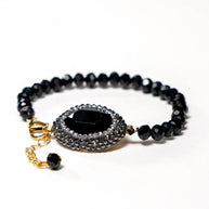 Handcrafted Grania bracelet featuring a strand of black beads with a sparkling black zirconia stone centerpiece - Anima Collection by Iottigleam