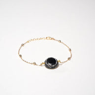 Handcrafted Embla chain bracelet featuring a polished black onyx stone on a gold-plated link chain - Anima Collection by iottigleam
