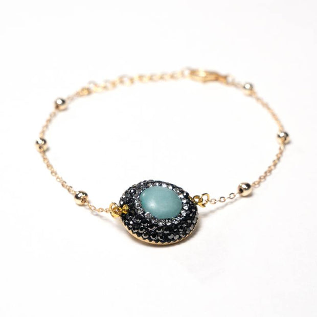 Handcrafted Embla chain bracelet featuring a centered blue quartz stone on a polished gold-plated link chain - Anima Collection by iottigleam