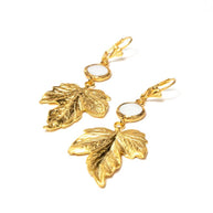 Handcrafted Freyja gold-plated leaf earrings featuring a centered, engraved natural sea shell stone - Anima Collection by iottigleam