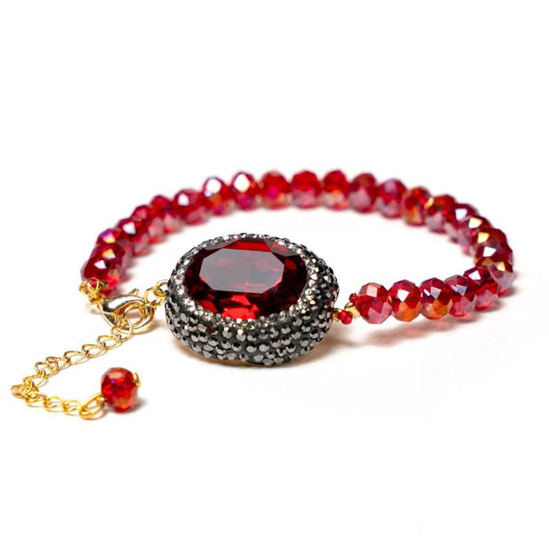 Handcrafted Grania I bracelet featuring reflective red shiny beads with a centered red zirconia stone - Anima Collection by iottigleam