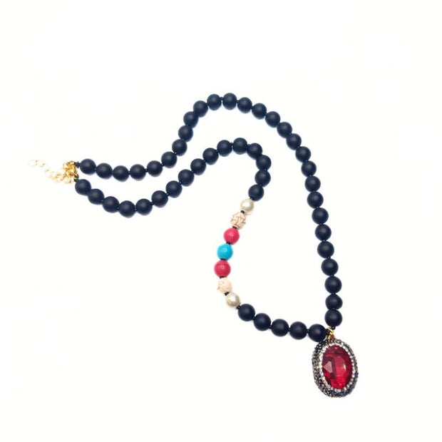 Handcrafted Morana necklace featuring a red zirconia center stone, black beads, and colorful accent beads - Anima Collection by Iottigleam
