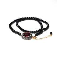 Handcrafted Padma multi-line bracelet featuring several strands of black beads with a centered red zirconia stone - Anima Collection by Iottigleam