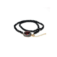 black beads bracelet with a centered red zirconia stone
